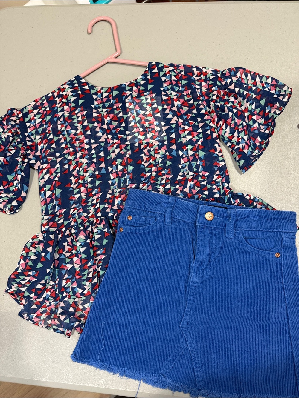 kidpik Navy Geometric Peplum Blouse with Pink and Teal Accents